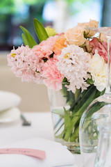 Flower table decorations for holidays and wedding dinner. Table set for holiday, event, party or wedding reception in outdoor restaurant.