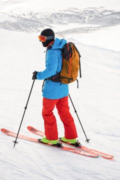 Skier skiing on snow covered mountains
