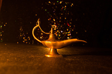Antique Aladdin arabian nights genie style oil lamp with soft light white smoke, Dark background....