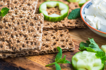 Fototapeta premium Snack from Wholegrain Rye Crispbread Crackers and Cucumber