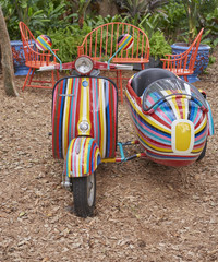 brightly painted motor scooter with side-car