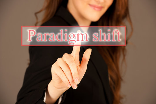 Attractive business woman pressing a virtual button paradigm shift