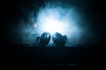 DJ Spinning, Mixing, and Scratching in a Night Club, Hands of dj tweak various track controls on...