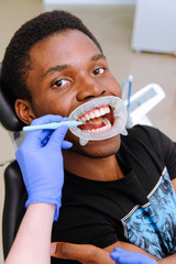 African male patient getting dental treatment in dental clinic