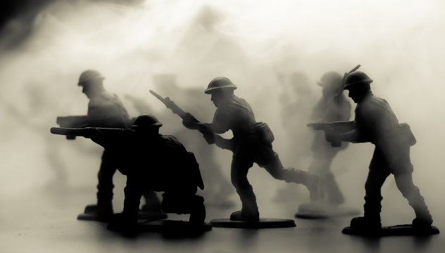 War Concept. Military silhouettes fighting scene on war fog sky background, World War Soldiers Silhouettes Below Cloudy Skyline At night. Attack scene. Armored vehicles