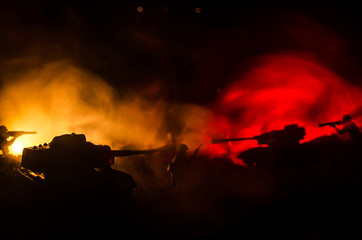 War Concept. Military silhouettes fighting scene on war fog sky background, World War Soldiers Silhouettes Below Cloudy Skyline At night. Attack scene. Armored vehicles.