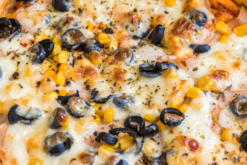 Closeup Detail of Pizza with Cheese, Olives and Sweet Corn