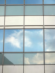 office business building windows with reflected clouds