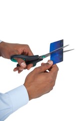 Businessman cutting credit card with scissors
