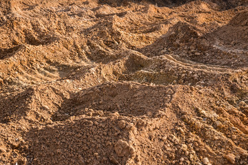 Clay and sand in the quarry. Beautiful unusual background similar to the surface of the planet Mars or the moon