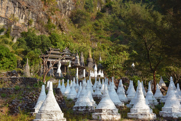 Fototapeta na wymiar View of the ancient wooden monastery at the foot of the mountain in Hpa-an, Myanmar