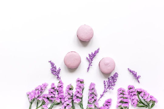 Fototapeta spring design pastel color with macaroons and flowers top view mock up