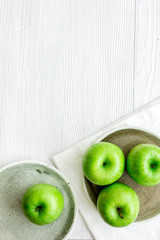 Healthy green food with apples on plates white background top view mock up