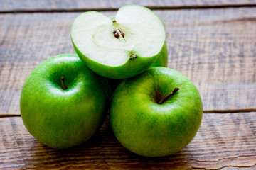 Healthy green food with apples on kitchen wooden background