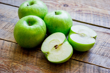 Healthy green food with apples on kitchen wooden background