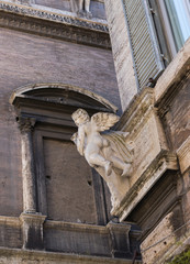 angel sculpture on the corner of old buildings