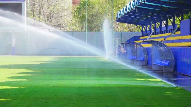 Football field watering, slow motion