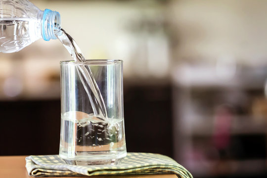 Glass of the purified water on the table bar in kitchenroom