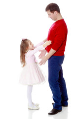 Little girl pulls her hands to his daddy.