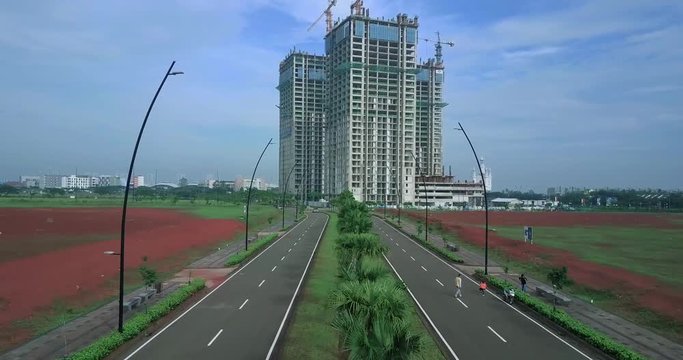 Video footage of empty road with street light and unfinished residential building. Professional shot in 4K resolution