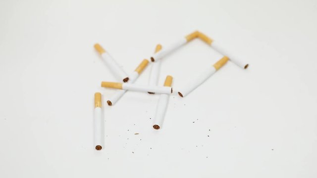Video footage of male hands crushing cigarettes, isolated on white background.