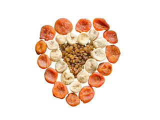 Assortment of dried figs, raisins and apricots in the form of heart isolated on white background