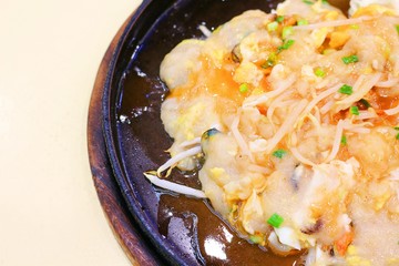 Mussels omelette on wooden pan