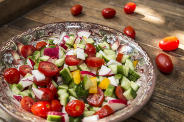 bowl with vegetable spring cut salad, tomato, pepper, radish, cucumber
