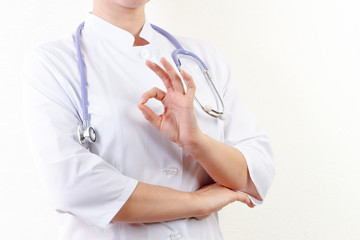 Doctor holding a tablet computer while using it isolated on white background