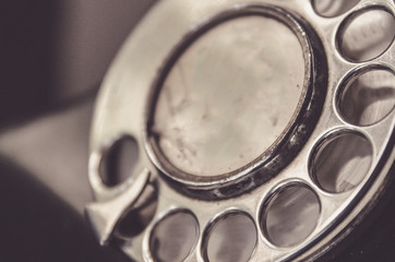 Macro shot rotary dial on grungy, old telephone (phone)