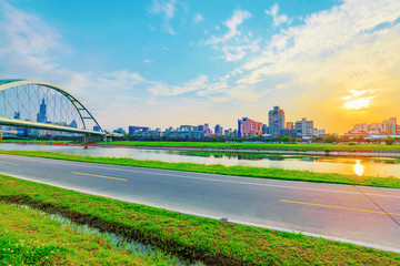 Riverside cycling path with sunset