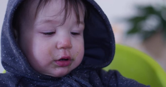 sick toddler boy with snot on face