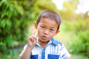 Portrait of young boy in nature, park or outdoors. cute kid outdoor. a child is smiling enjoying...