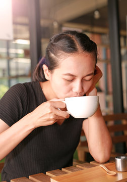 Woman drinking hot coffee in the morning.
