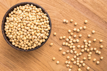 Soybean in wooden bowl put on wooden plank background