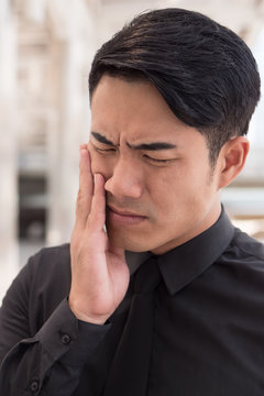 man suffering from toothache, oral problem