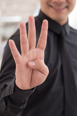 businessman pointing up number 4 finger hand gesture