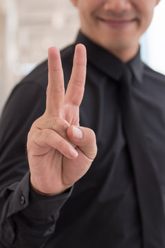 businessman pointing up number 2 finger hand gesture, v sign victory