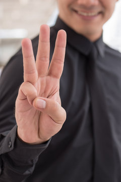 businessman pointing up number 3 finger hand gesture