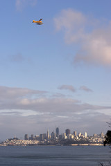 Fototapeta na wymiar Float Plane Flies San Francisco California Downtown City Skyline Fisherman's Wharf