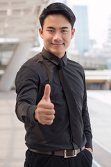 successful businessman pointing thumb up