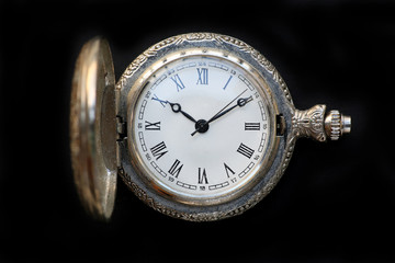 Close up pocket watch on black background