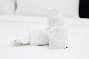 Bath towels on the bed of hotel bedroom