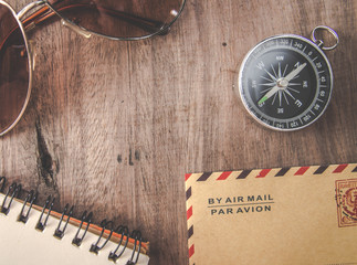travel concept vintage and modern compass on vintage map with note paper and pen