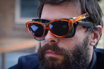 Man wearing three pairs of sunglasses