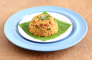 South Indian traditional vegetarian rice dish, puliyogare, made from rice and a paste containing tamarind and other ingredients.