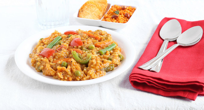 South Indian traditional vegetarian rice dish, bisi bele bath, with rice and pigeon pea as the main ingredients.