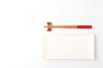 Empty plate and chopsticks on white Background