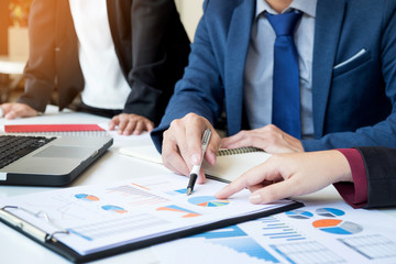 Team work process. young business managers crew working with new startup project. labtop on wood table, typing keyboard, texting message, analyse graph plans