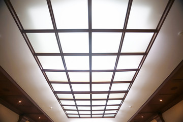 Glowing ceiling with glasses in the office
